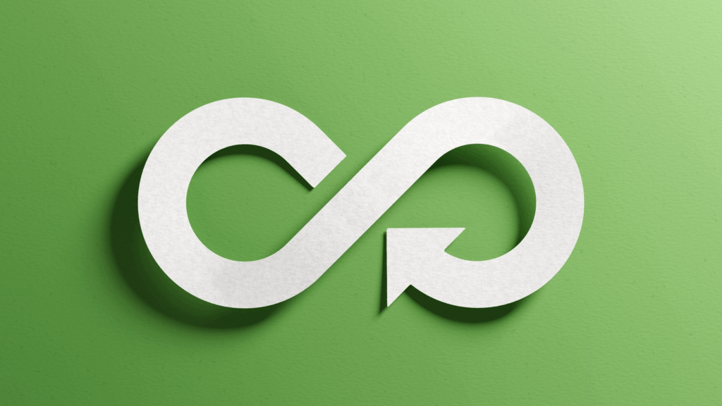 Circular economy concept image of a white never-ending loop against a green background.