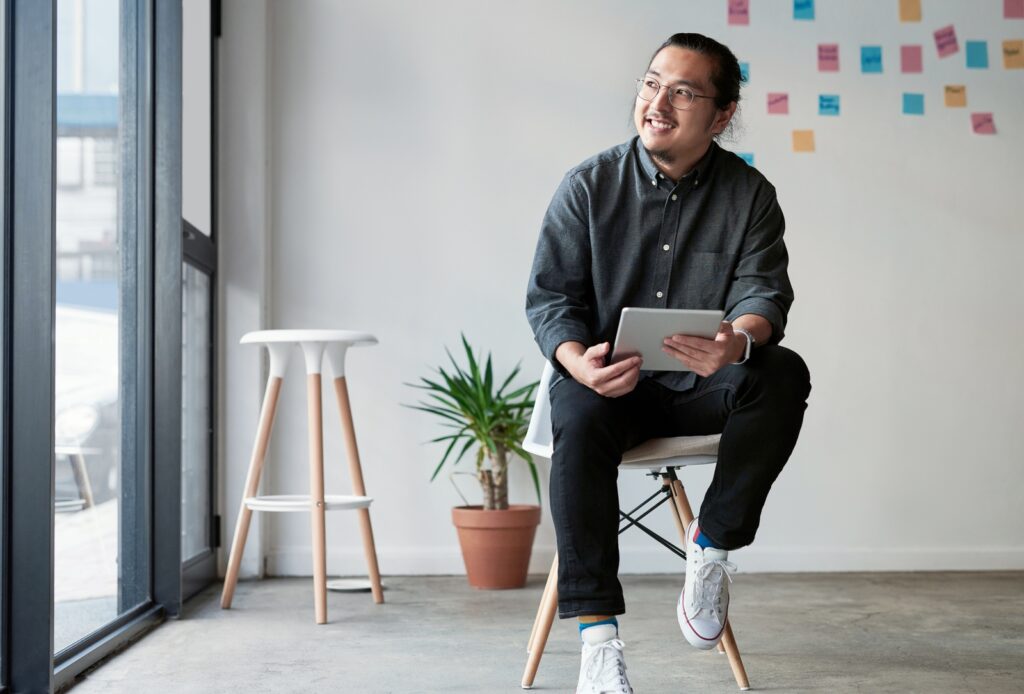 Startup founder with creative idea, sitting in his office planning the future.